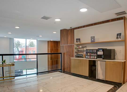 A reception area with a counter and a balcony with a view of the outside.