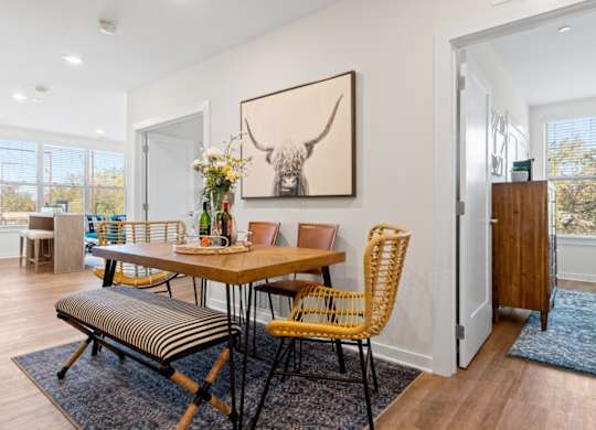 A dining room with a wooden table and chairs.