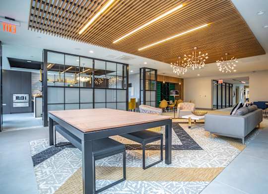 A modern dining room with a wooden table and chairs.