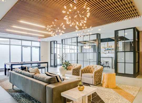 A modern living room with a large sofa and a wooden ceiling.
