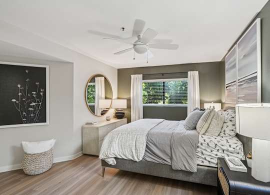 A bedroom with a bed, nightstand, and a fan at The Magwood in Boulder Colorado