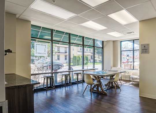 A conference room with a long table and chairs.