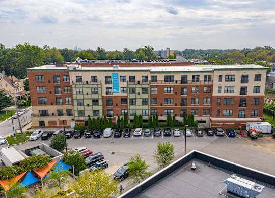 A large multi-story building with a parking lot in front.