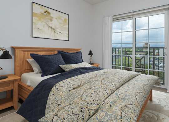 A bedroom with a large bed and a view of the ocean.
