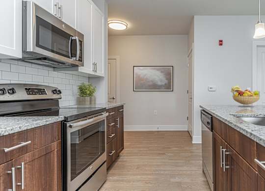 A kitchen with wooden cabinets and granite countertops.