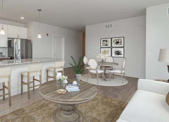 A modern kitchen with a dining table and chairs.