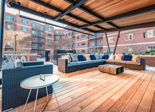 a rooftop patio with furniture and a table