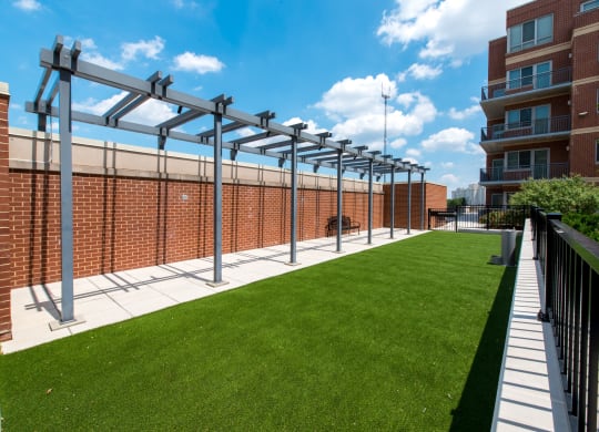 a green lawn in front of a brick building