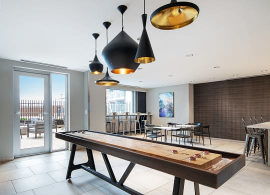 a pool table in a room with tables and chairs and a bar