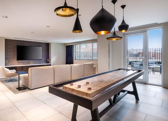 a living room with a pool table and a tv