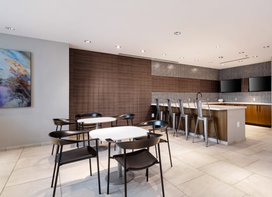 a dining room with tables and chairs and a bar