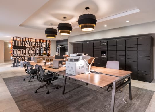 a conference room with desks and chairs and a machine on a table