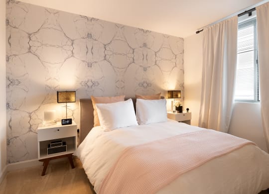a bedroom with a white bed and white curtains