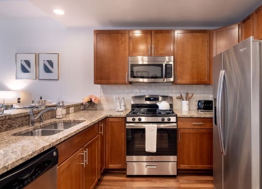 full kitchen with stainless steel appliances and granite counter tops