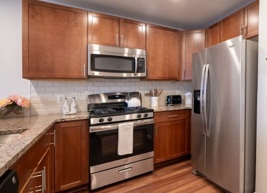 a kitchen with stainless steel appliances and wooden cabinets