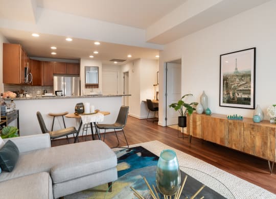 a living room and kitchen with a couch and a table