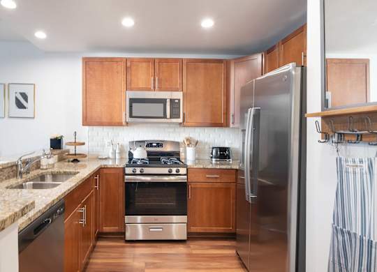 A kitchen with wooden cabinets and stainless steel appliances.