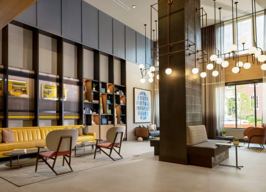 a lobby with a yellow couch and chairs