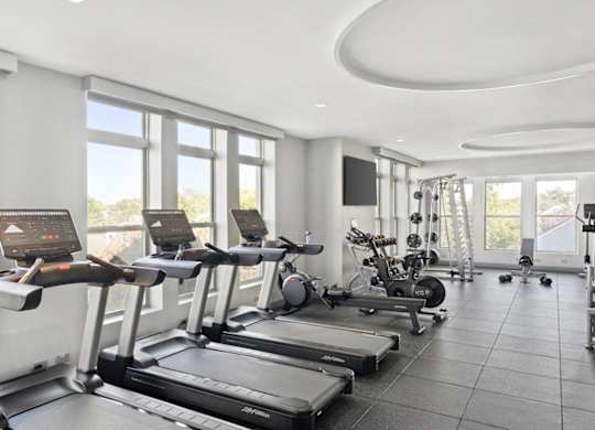 A gym with treadmills and exercise equipment.