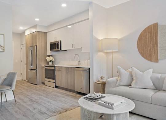 A modern kitchen with a dining table and a couch.