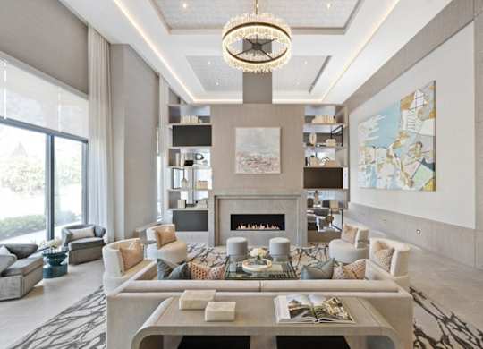 A modern living room with a fireplace and a chandelier.