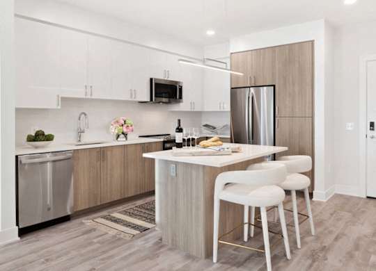 A kitchen with a white counter and a refrigerator.
