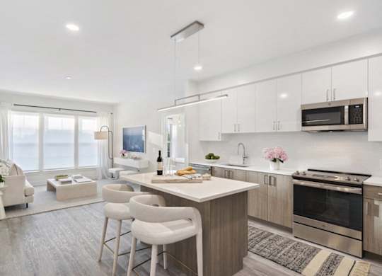A modern kitchen with a dining area and a living room.