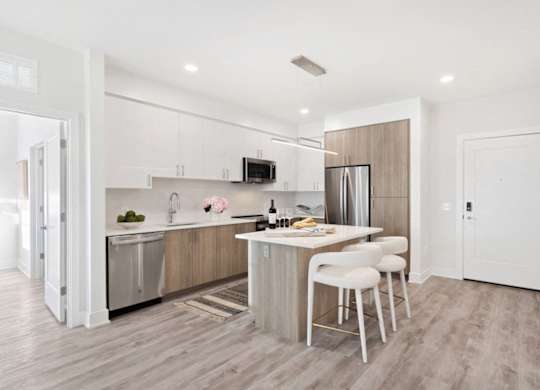 A modern kitchen with a dining table and chairs.
