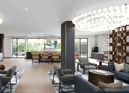 A modern living room with a large grey sofa and a wooden coffee table.