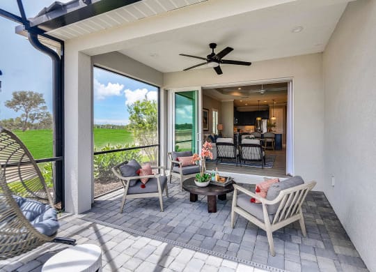 A balcony with lounge chairs and a ceiling fan  at Marisol, Bradenton, 34211