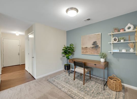 Front door to living room with home office space