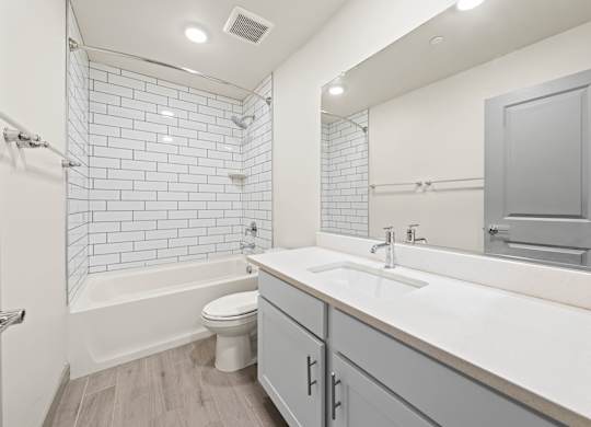 A white bathroom with a white toilet and a white sink.