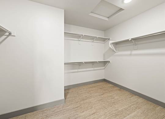 Empty room with white walls and wooden floor.