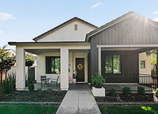 A modern house with a front porch and a covered entryway.
