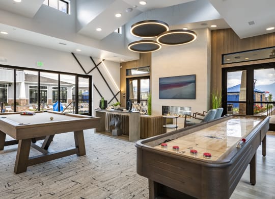 a game room with pool table, shuffle board,  and a television