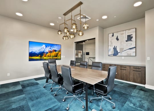 a conference room with a wooden table and chairs
