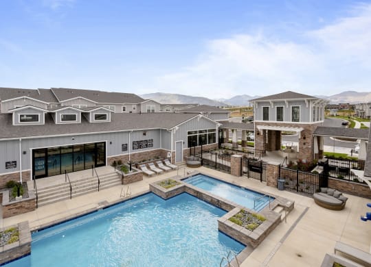 a large swimming pool with a building in the background