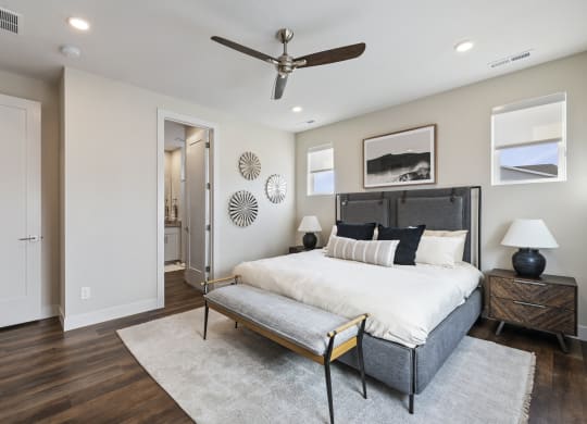 Furnished bedroom with ceiling fan and wood plank flooring