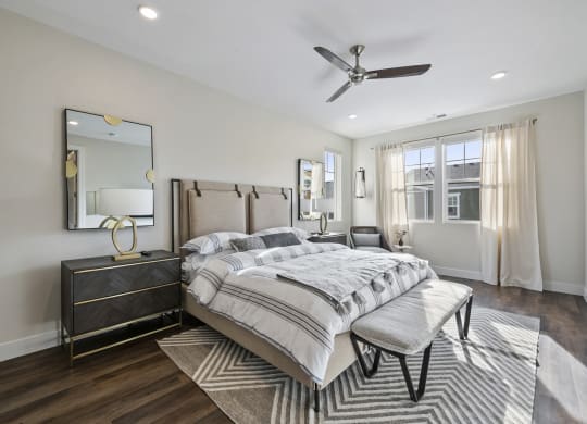 Furnished bedroom with ceiling fan and wood plank flooring