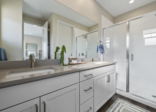 Decorated bathroom with large countertop and white vanity cabinets