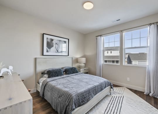 Furnished bedroom with wood plank flooring