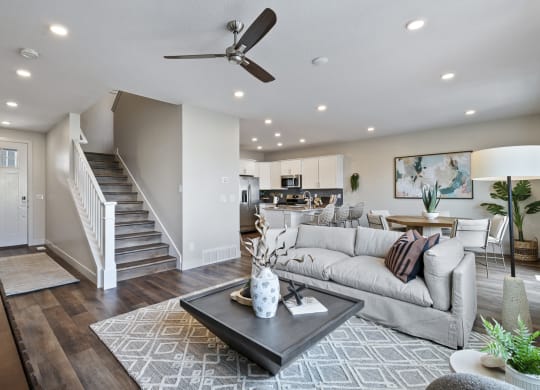 Furnished living space with ceiling fan and wood plank flooring