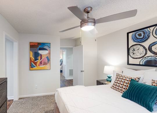 A bedroom with a bed, a ceiling fan, and two paintings on the wall at Inverness Cliffs, Alabama, 35242