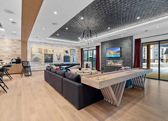 A modern living room with a large sectional sofa and a wooden coffee table.at 198 Milltown Apartments, Burlington  