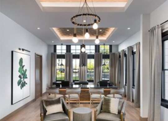 A modern living room with a large window and a hanging light fixture.at 198 Milltown Apartments, Burlington, 27215  