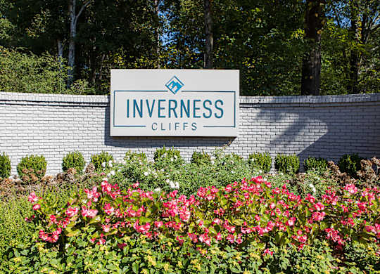 a sign in front of a garden of flowers at Inverness Cliffs, Alabama