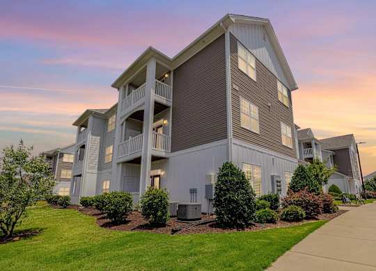 A large apartment building with a balcony on the second floor. at Concord Ridge Apartments, North Carolina, 28027