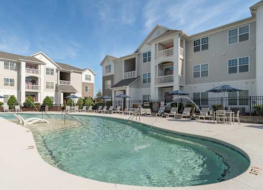 A swimming pool in front of apartment buildings. at Concord Ridge Apartments, Concord, NC