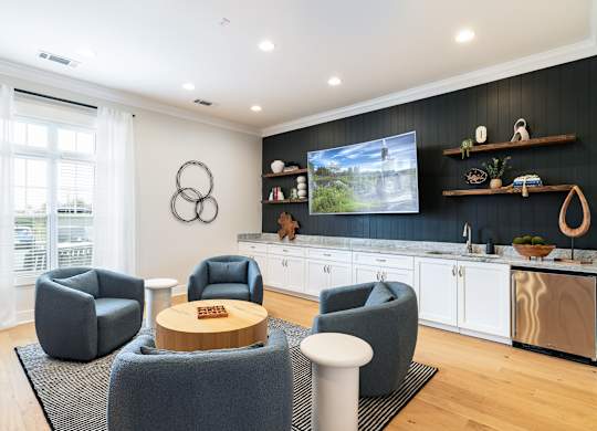 A modern living room with grey armchairs and a wooden coffee table. at Concord Ridge Apartments, North Carolina, 28027