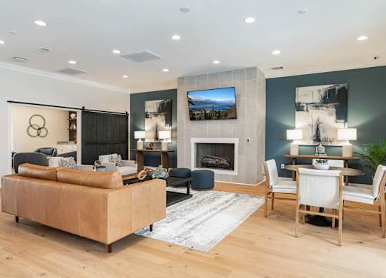 A modern living room with a fireplace and a television. at Concord Ridge Apartments, Concord, North Carolina